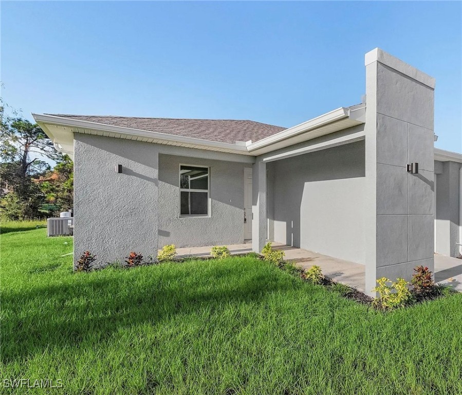 a front view of a house with a yard and a garage