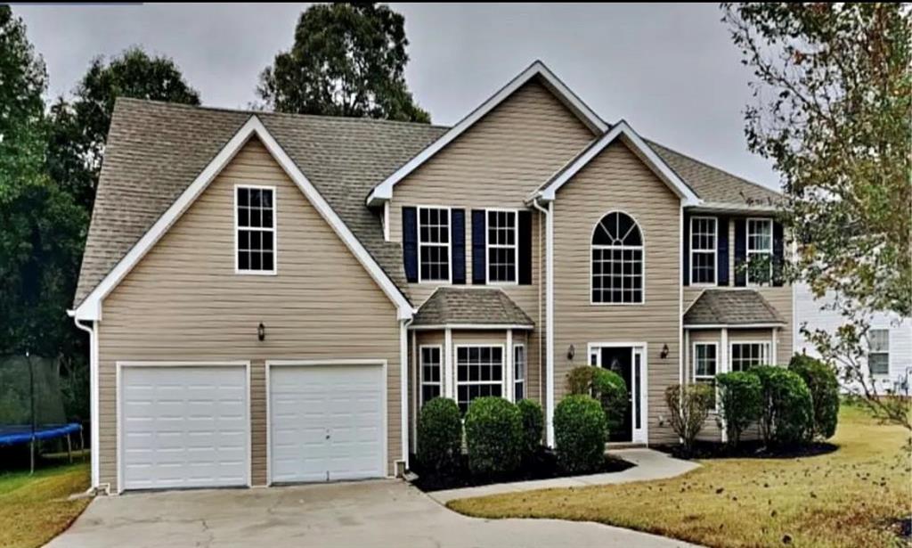 a view of a yard in front view of a house