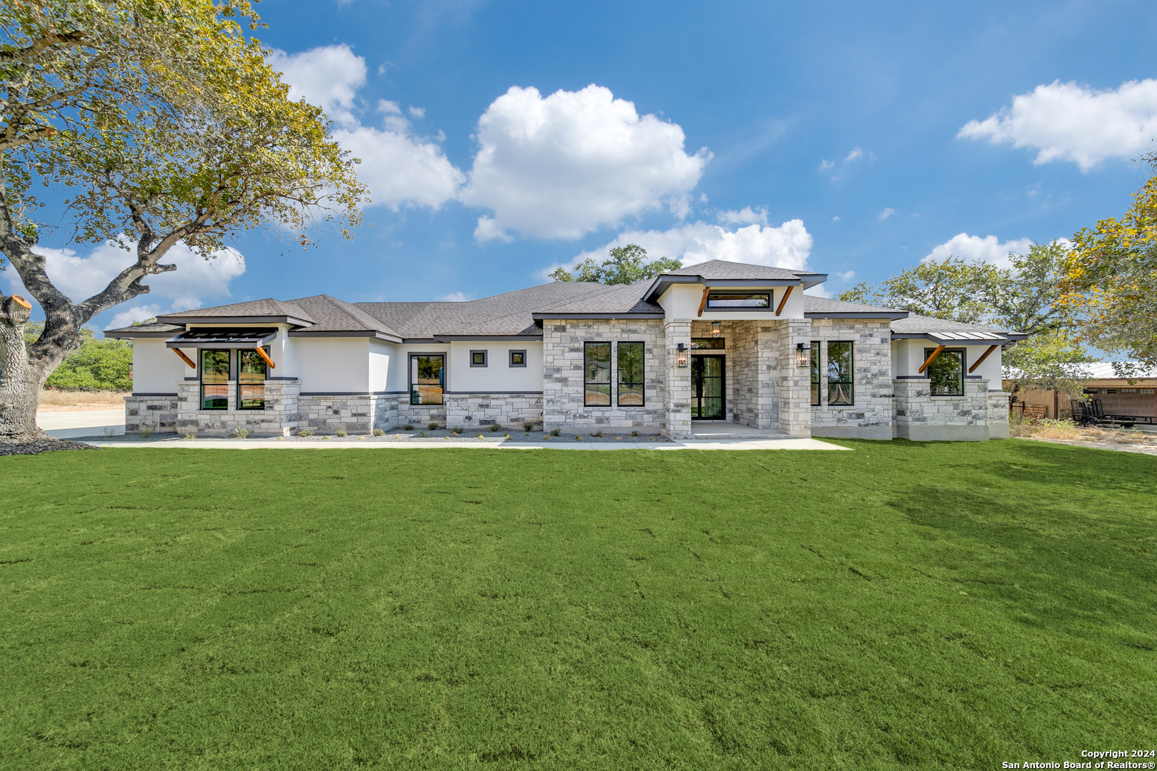 a front view of a house with a garden