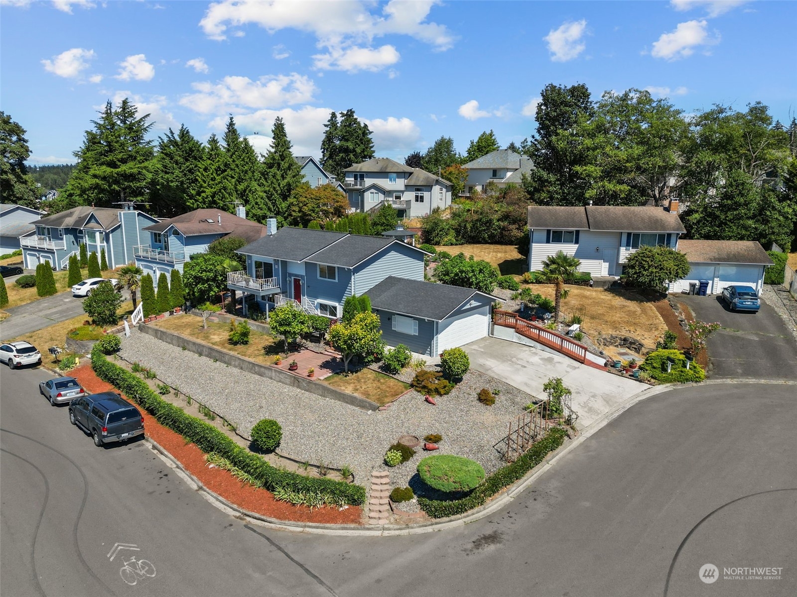 an aerial view of a house with a garden and houses