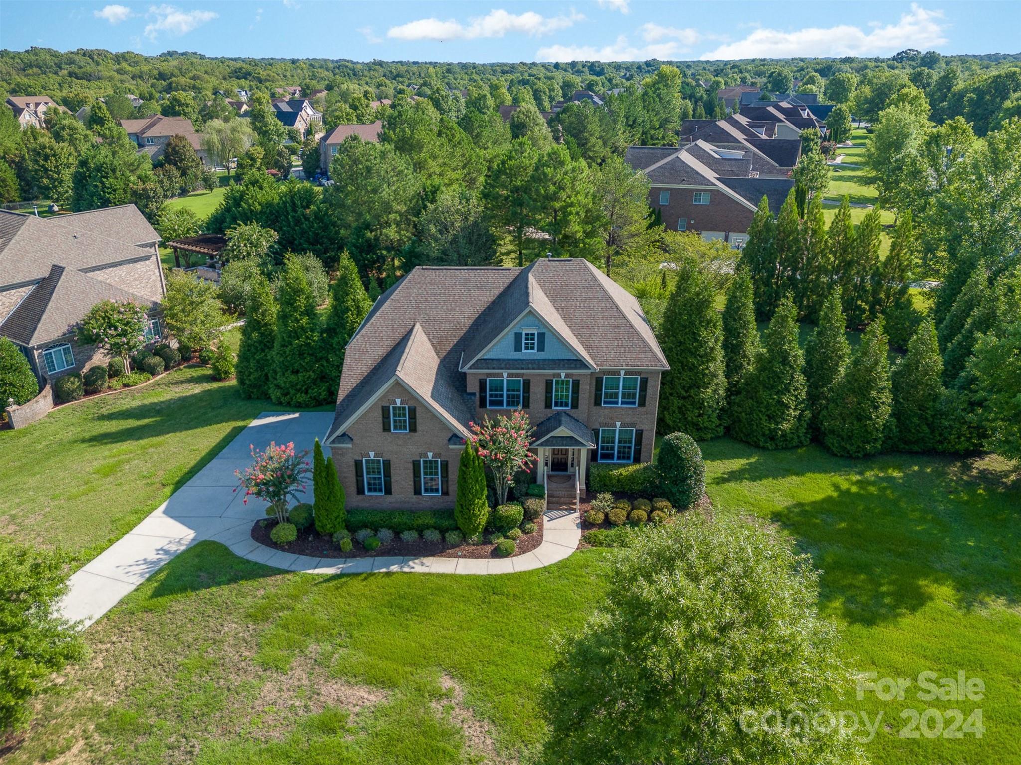 an aerial view of a house with swimming pool garden and patio