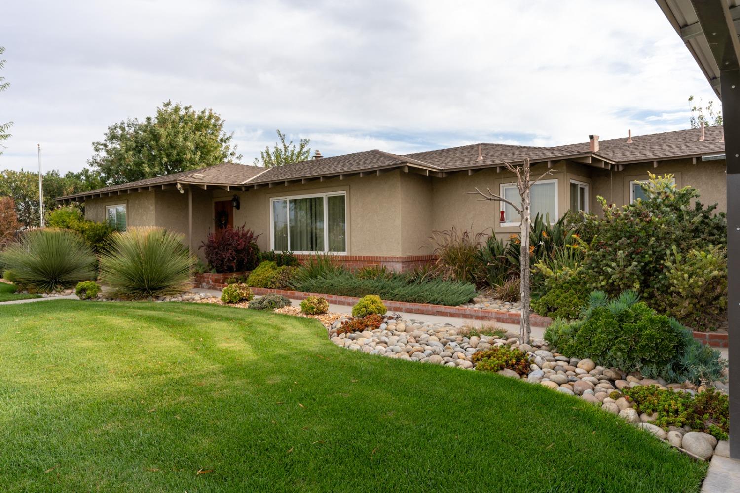 a front view of a house with garden