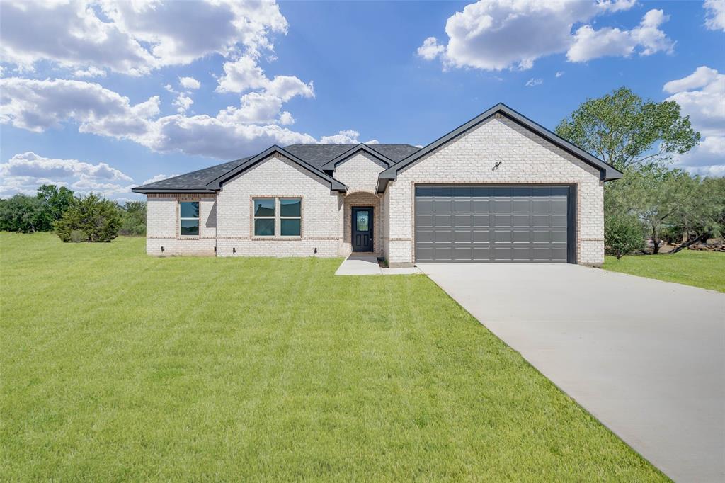 a front view of house with yard and green space