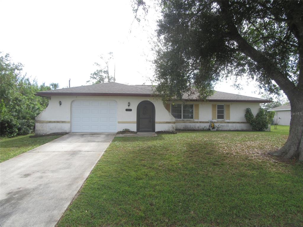 a front view of house with yard and trees