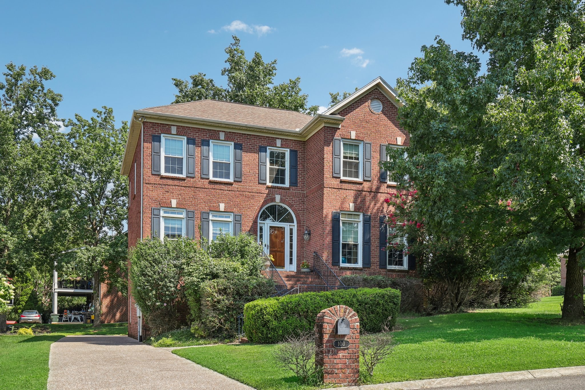 a front view of a house with a yard and fountain