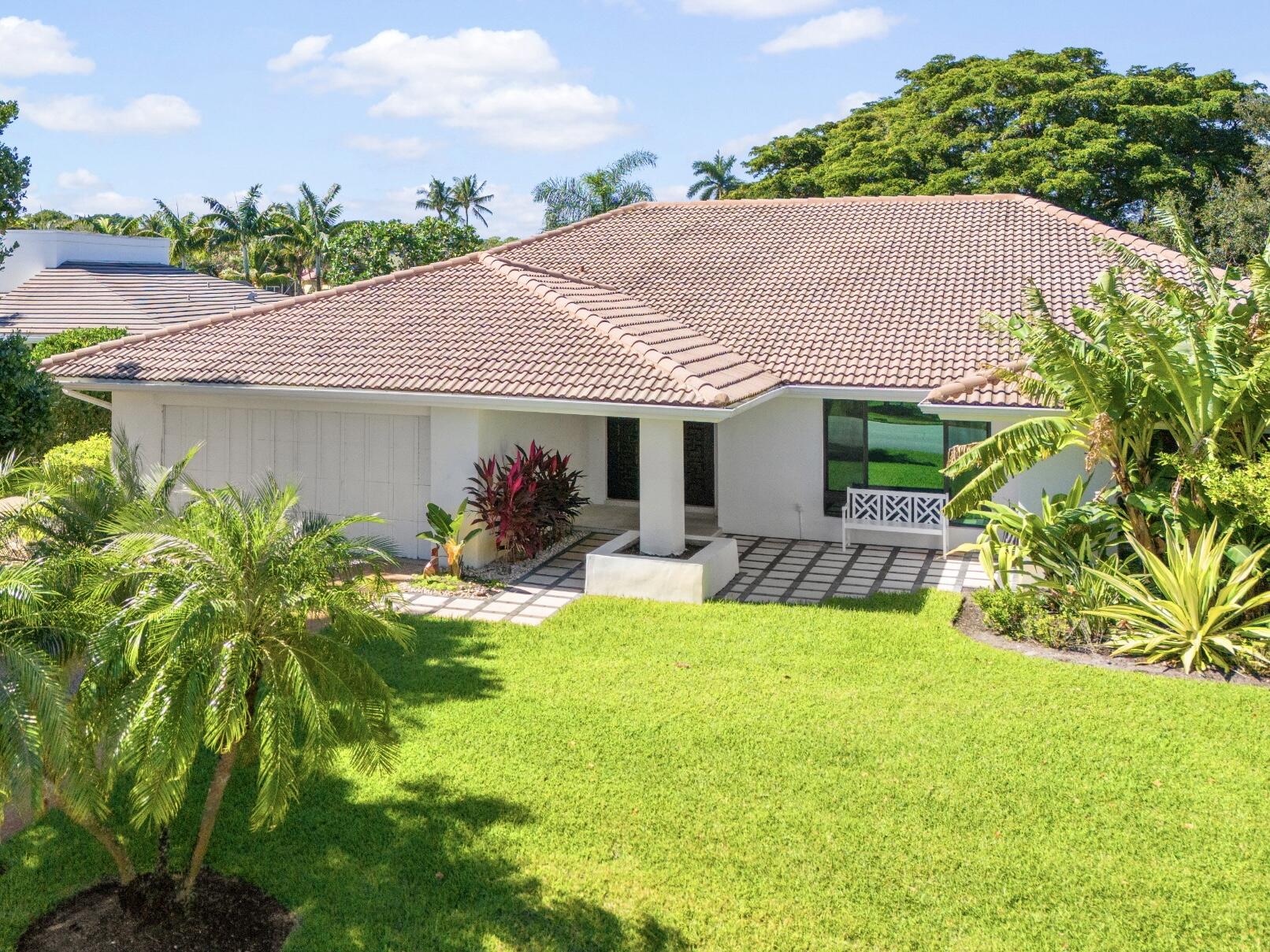 a view of house with garden and swimming pool