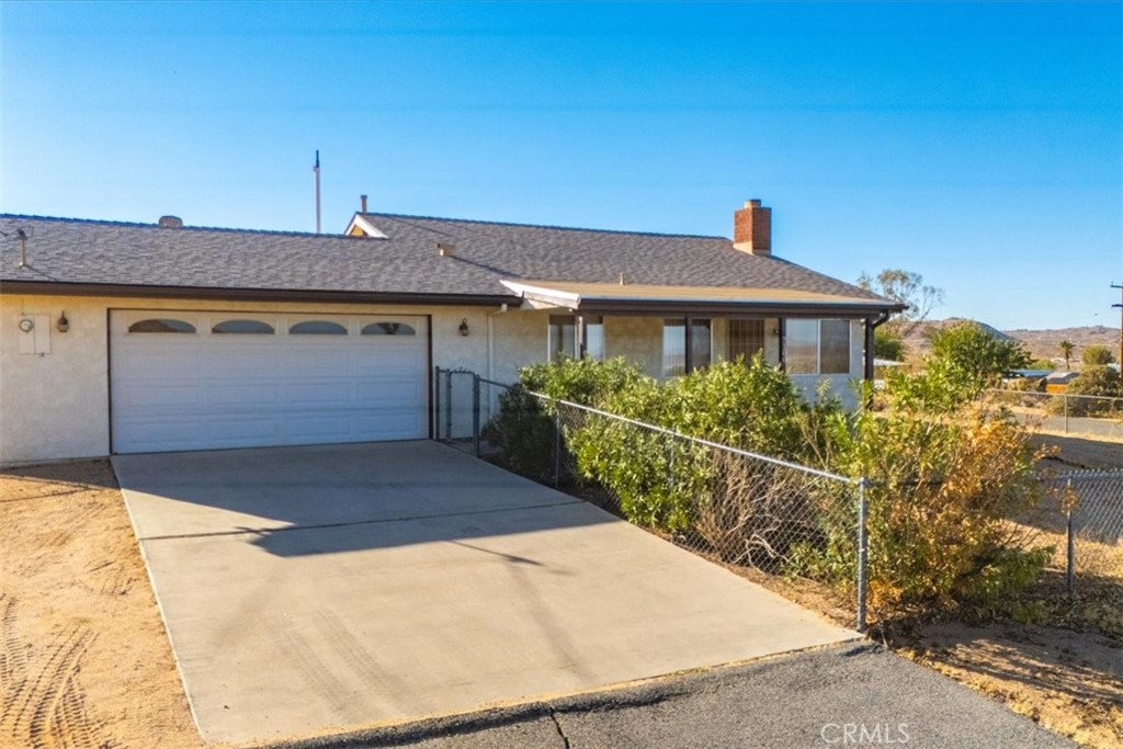 a view of a house with wooden fence