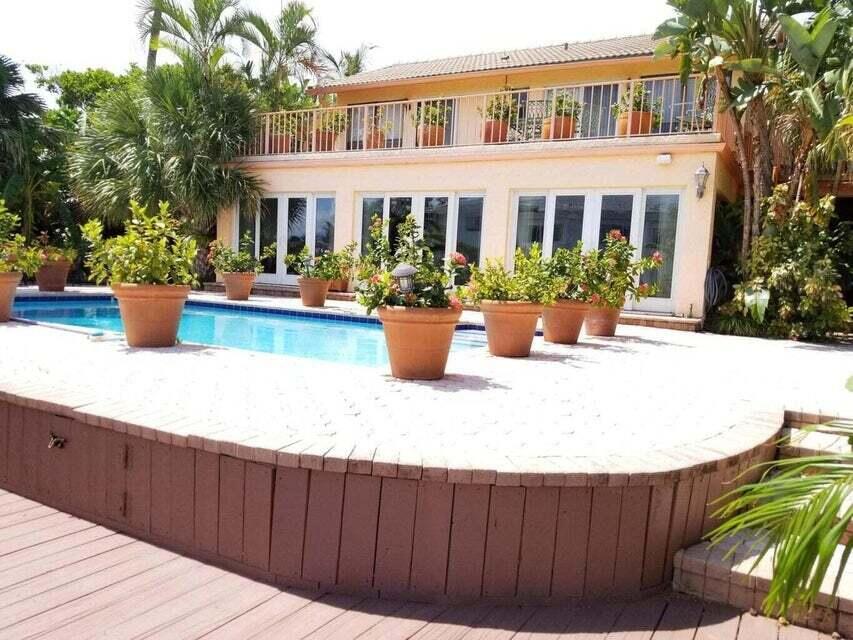 a view of a house with backyard sitting area and swimming pool