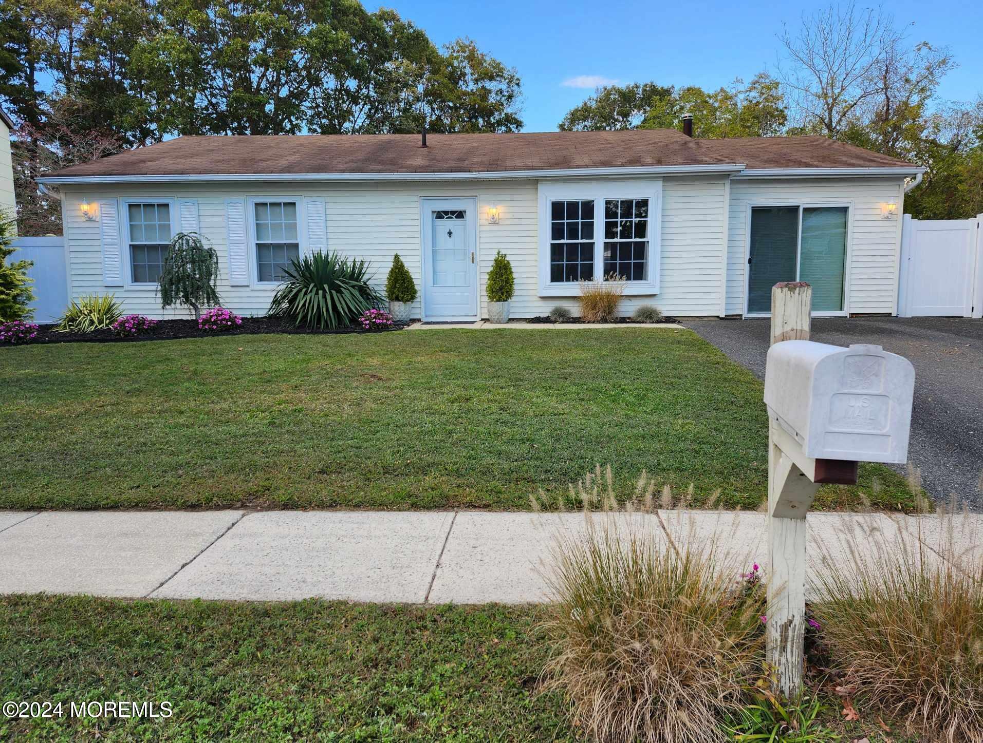 a front view of house with yard and outdoor seating