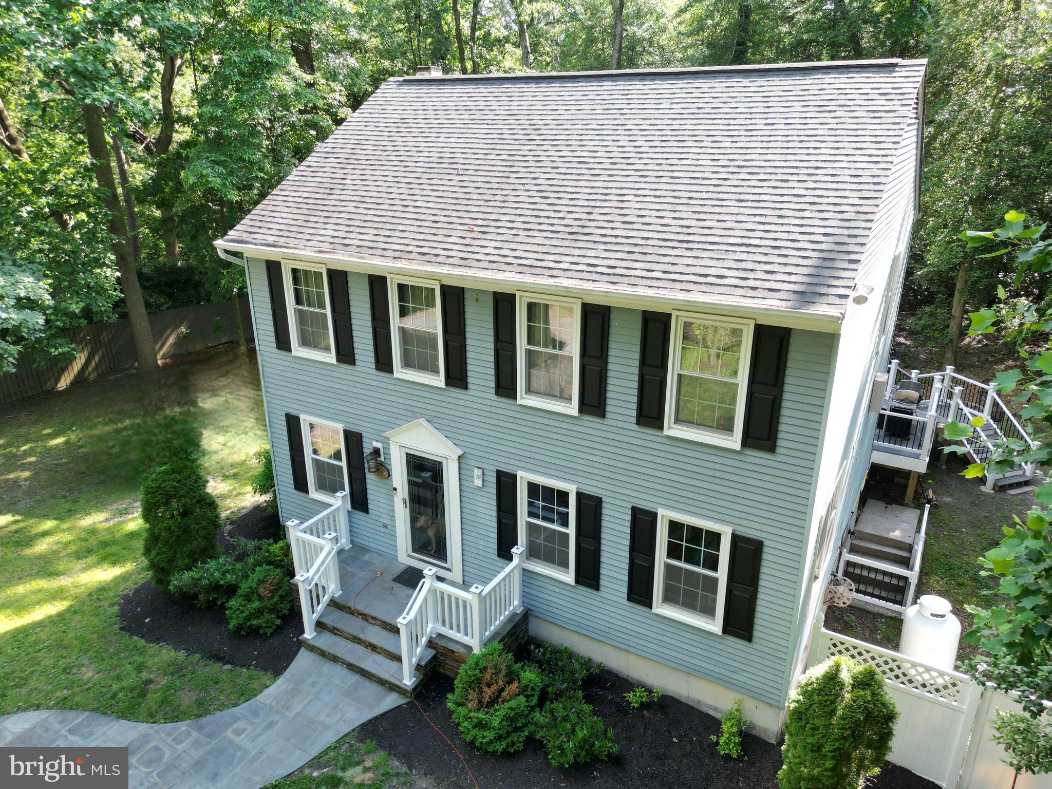 a aerial view of a house with a yard and potted plants