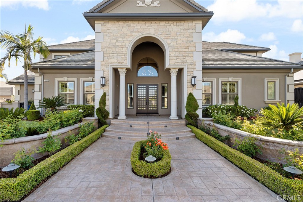 a front view of a house with garden