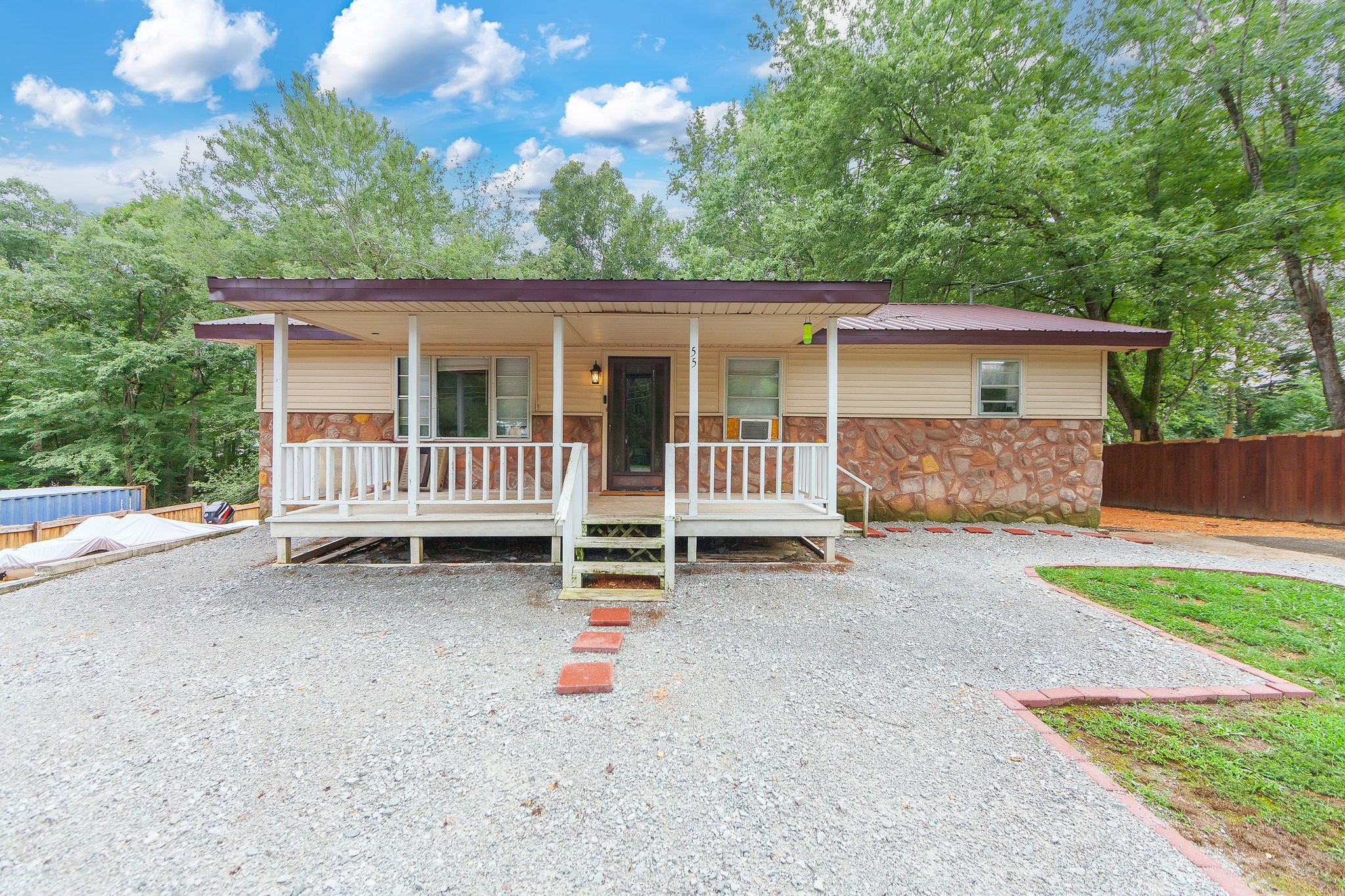 a backyard of a house with barbeque oven and fence