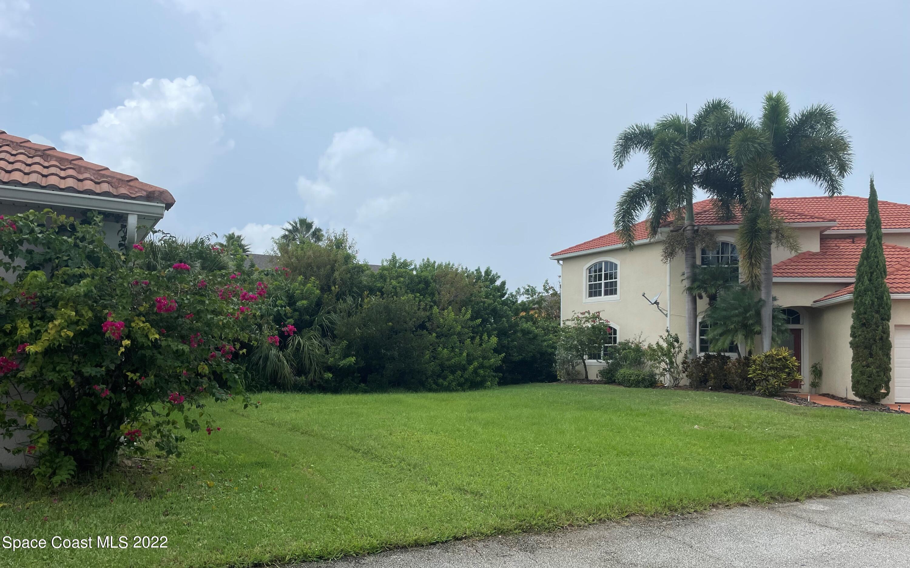 a front view of house with a garden