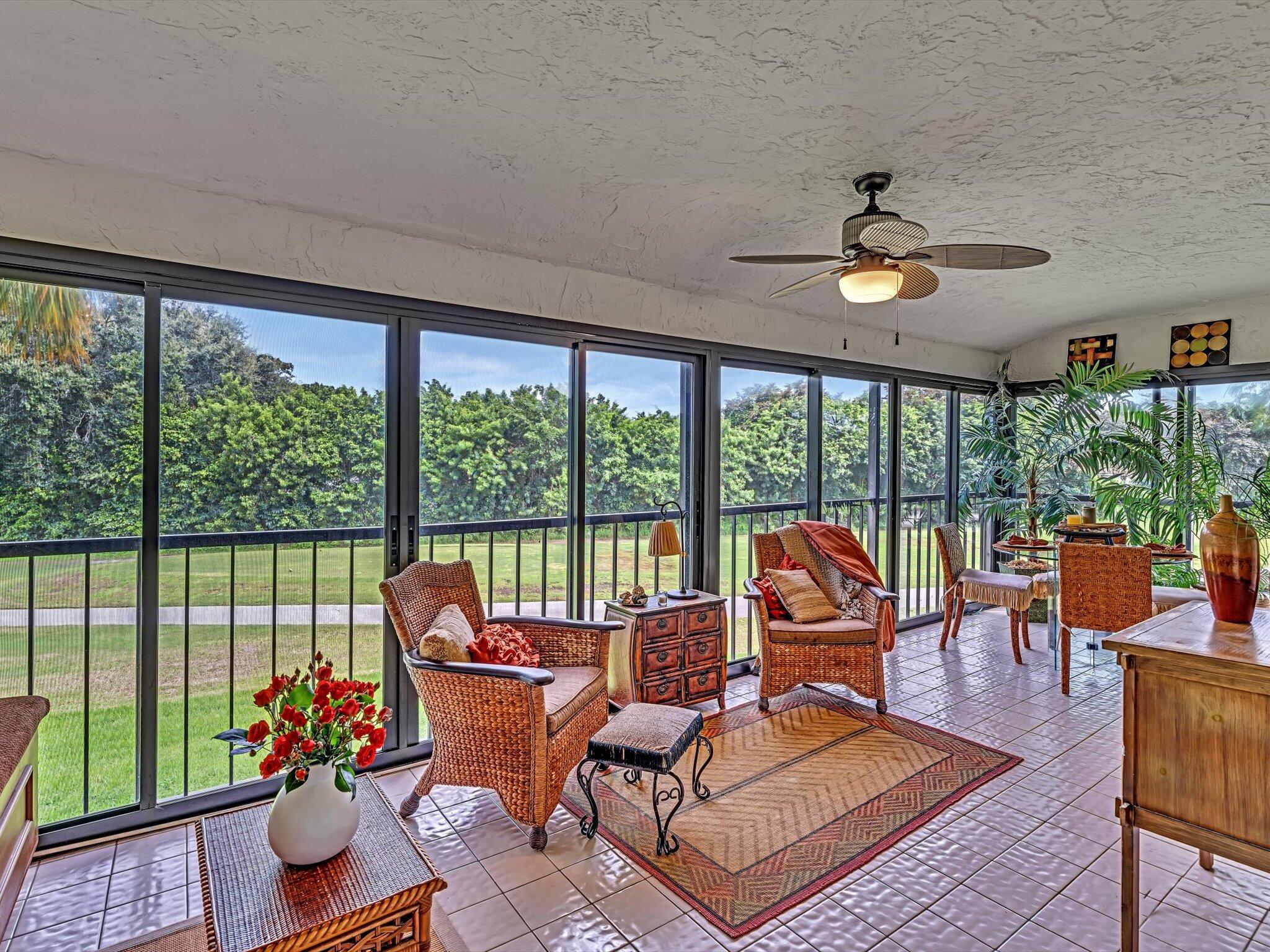 a living room with furniture and floor to ceiling windows