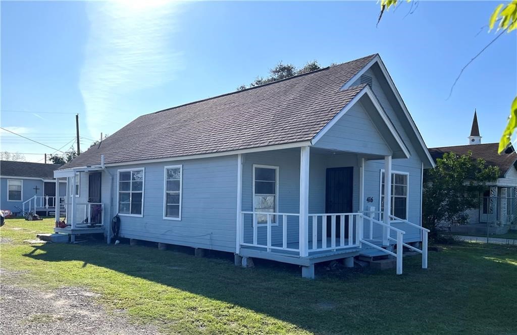 a view of a house with a yard and deck