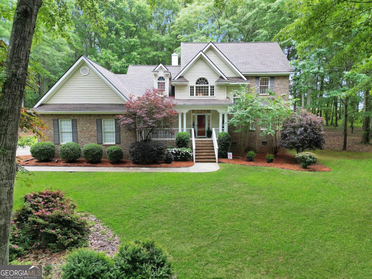 a front view of a house with a garden and plants