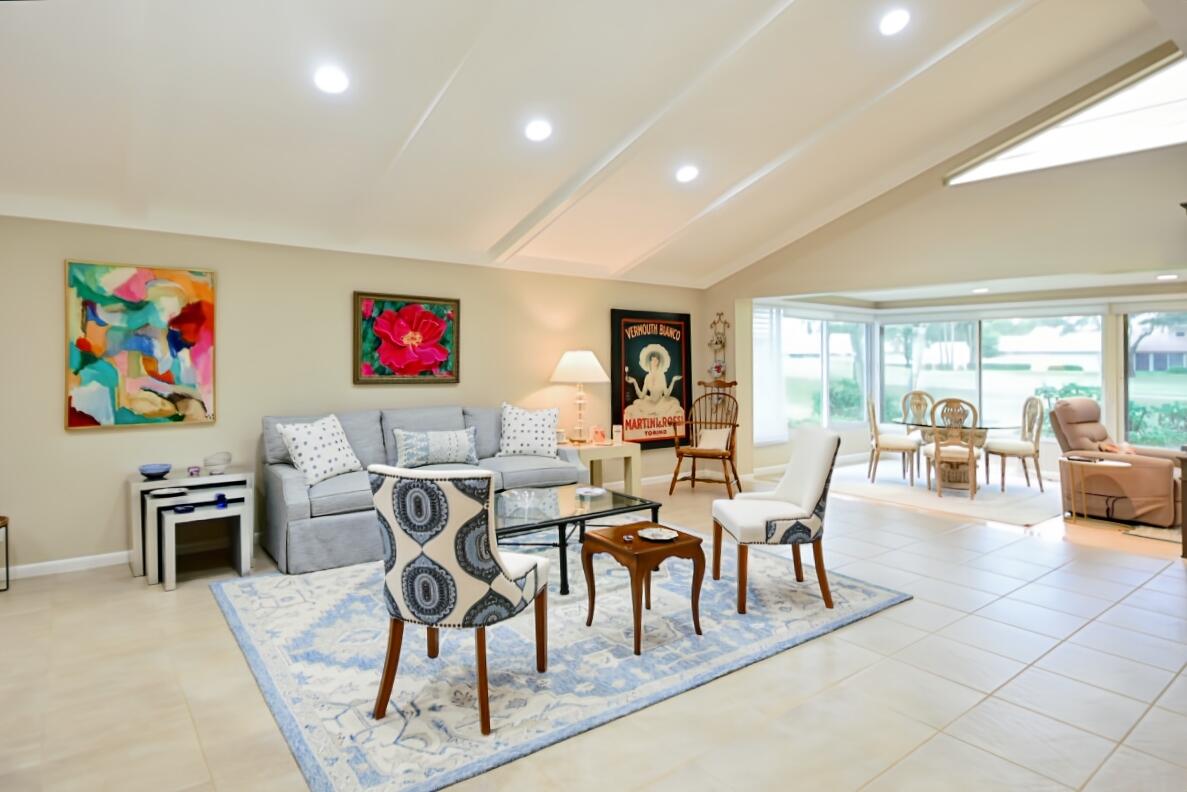 a view of a dining room with furniture a rug and a flat screen tv