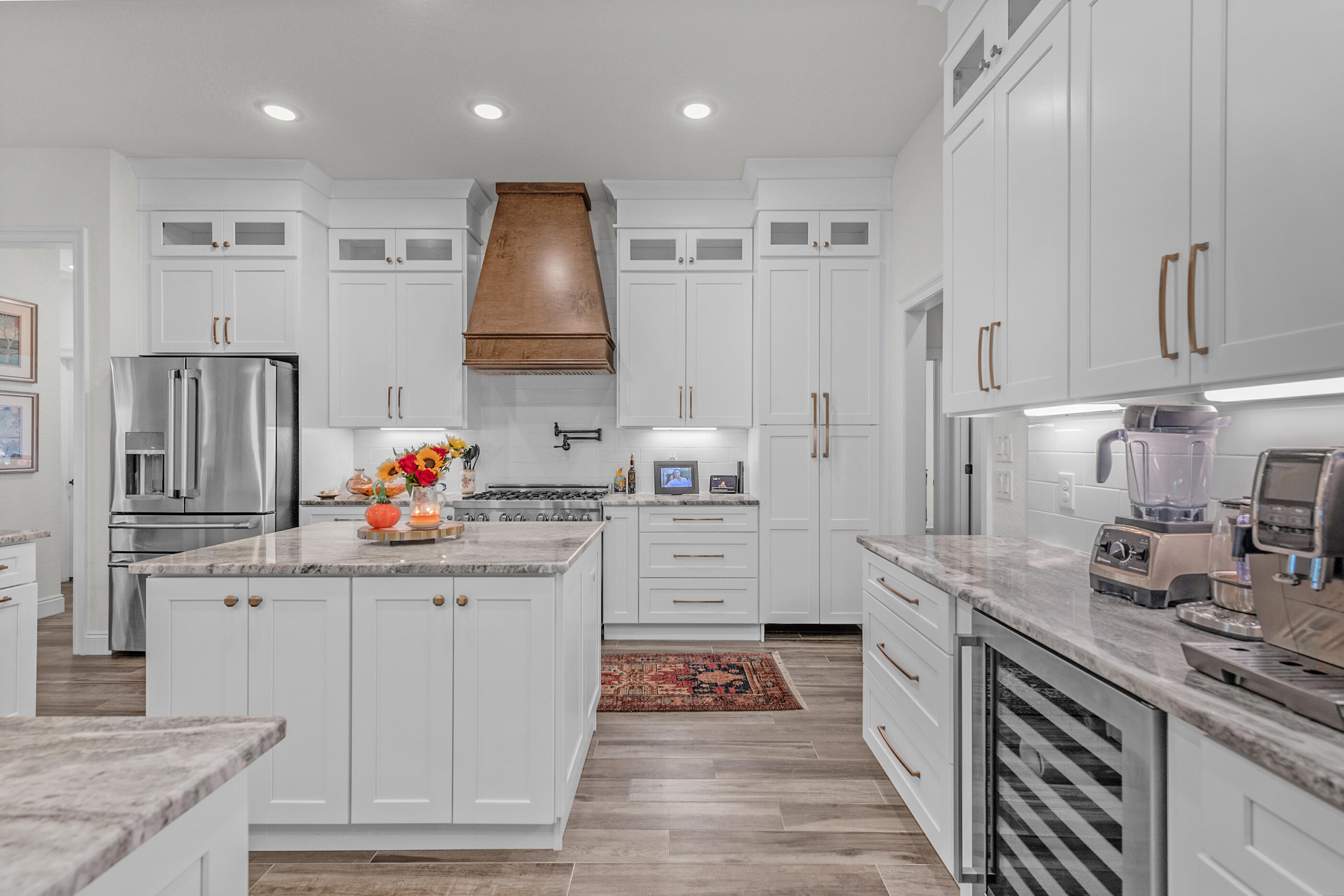 a kitchen with granite countertop a sink stainless steel appliances and cabinets