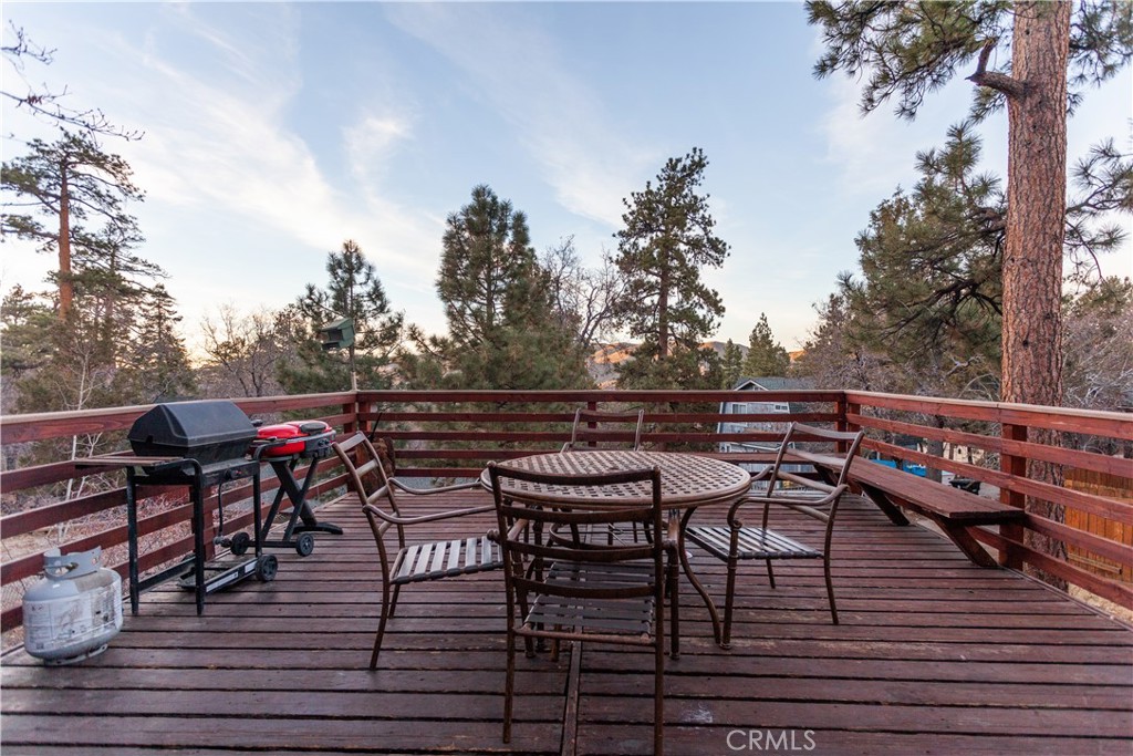 a view of a chairs and table on the roof deck