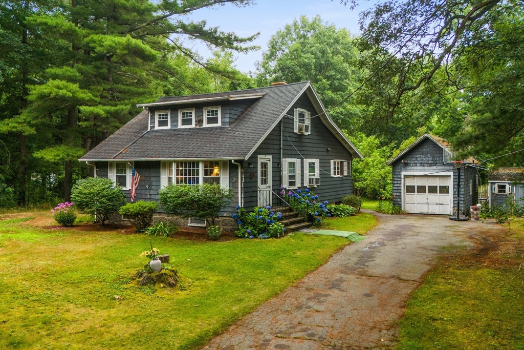 a front view of a house with yard and green space