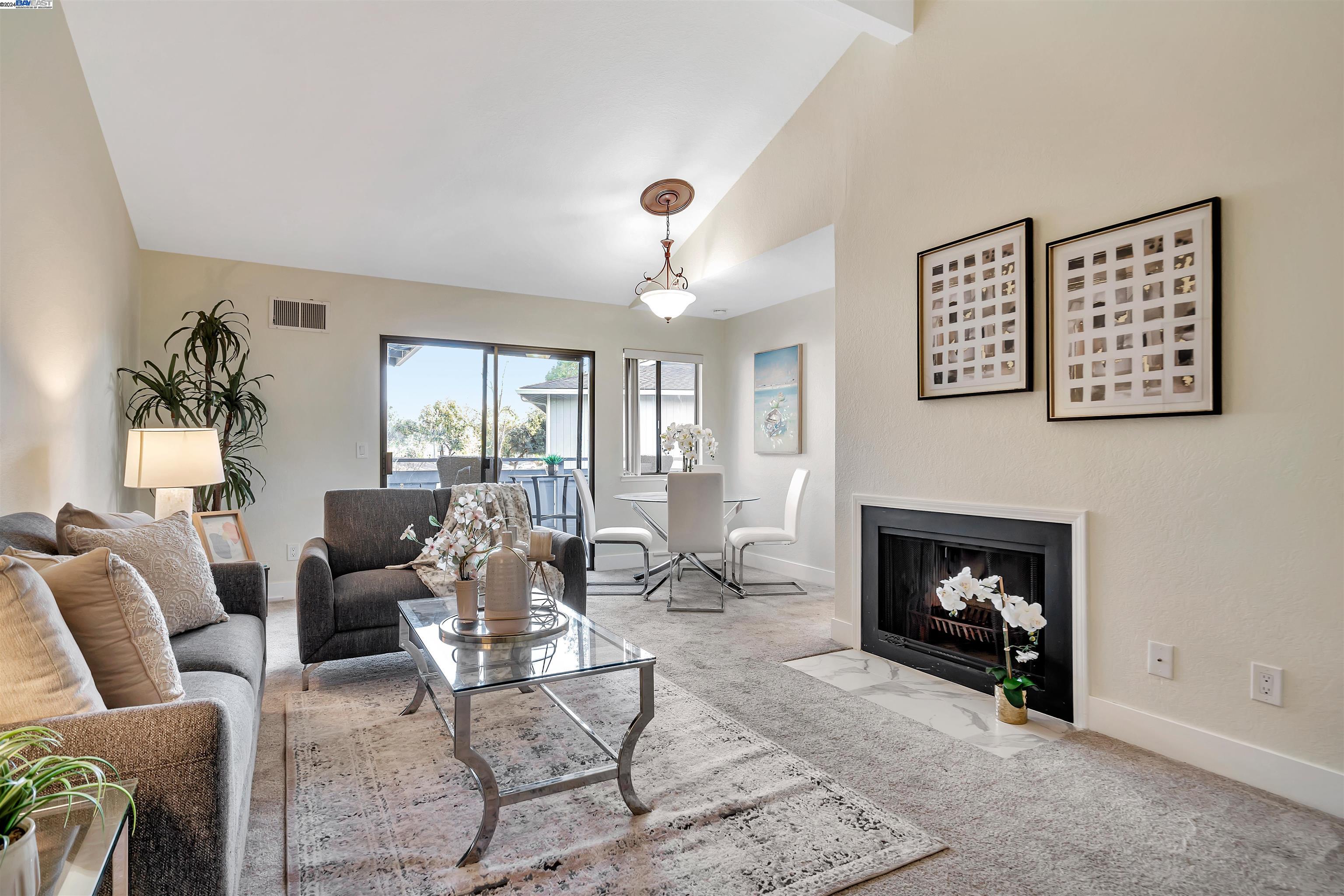 a living room with furniture and a fireplace