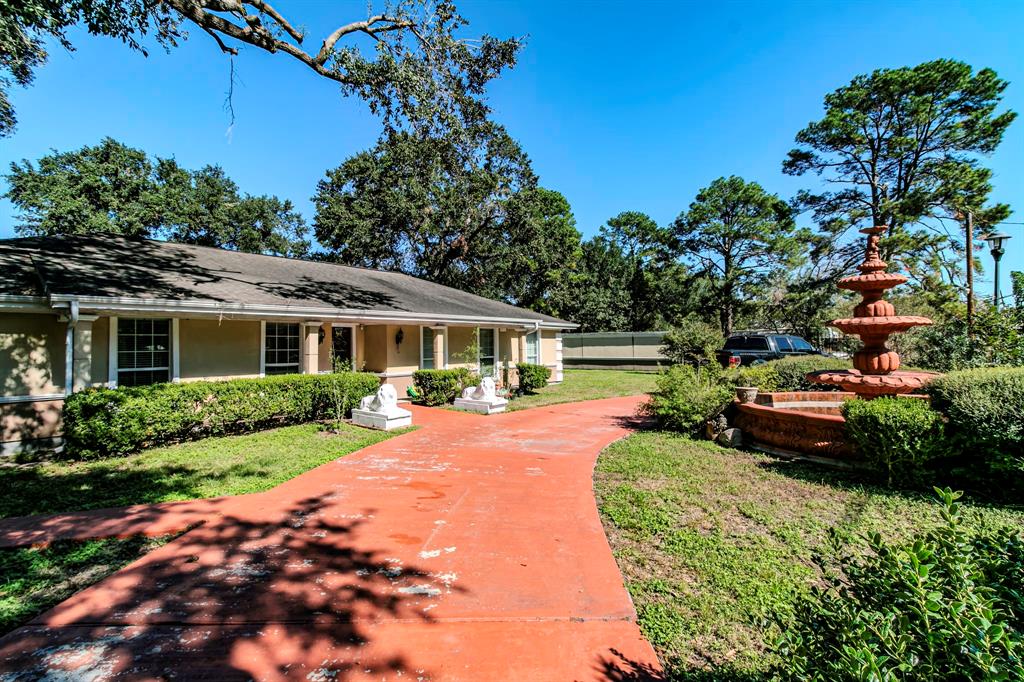 a front view of a house with yard patio and green space