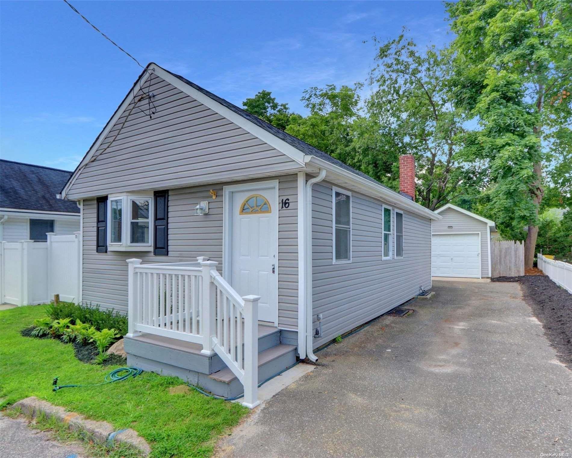 a view of a house with a yard and deck