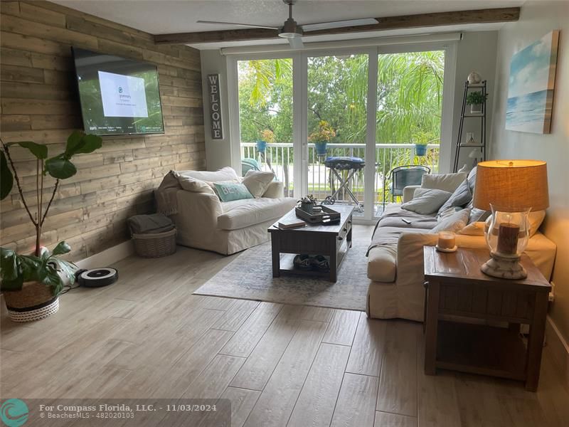 a living room with furniture and a floor to ceiling window