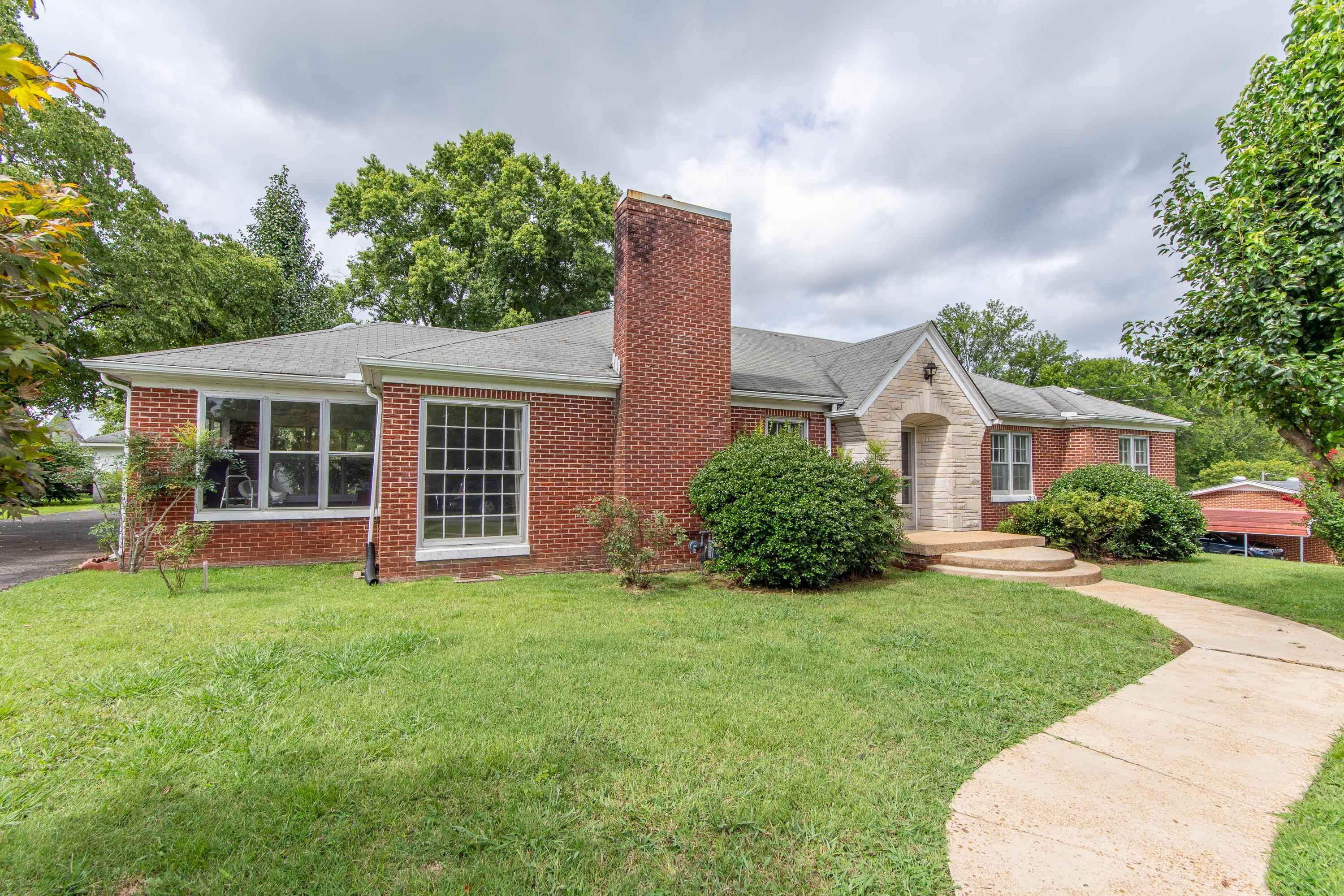 Ranch-style home featuring a front lawn