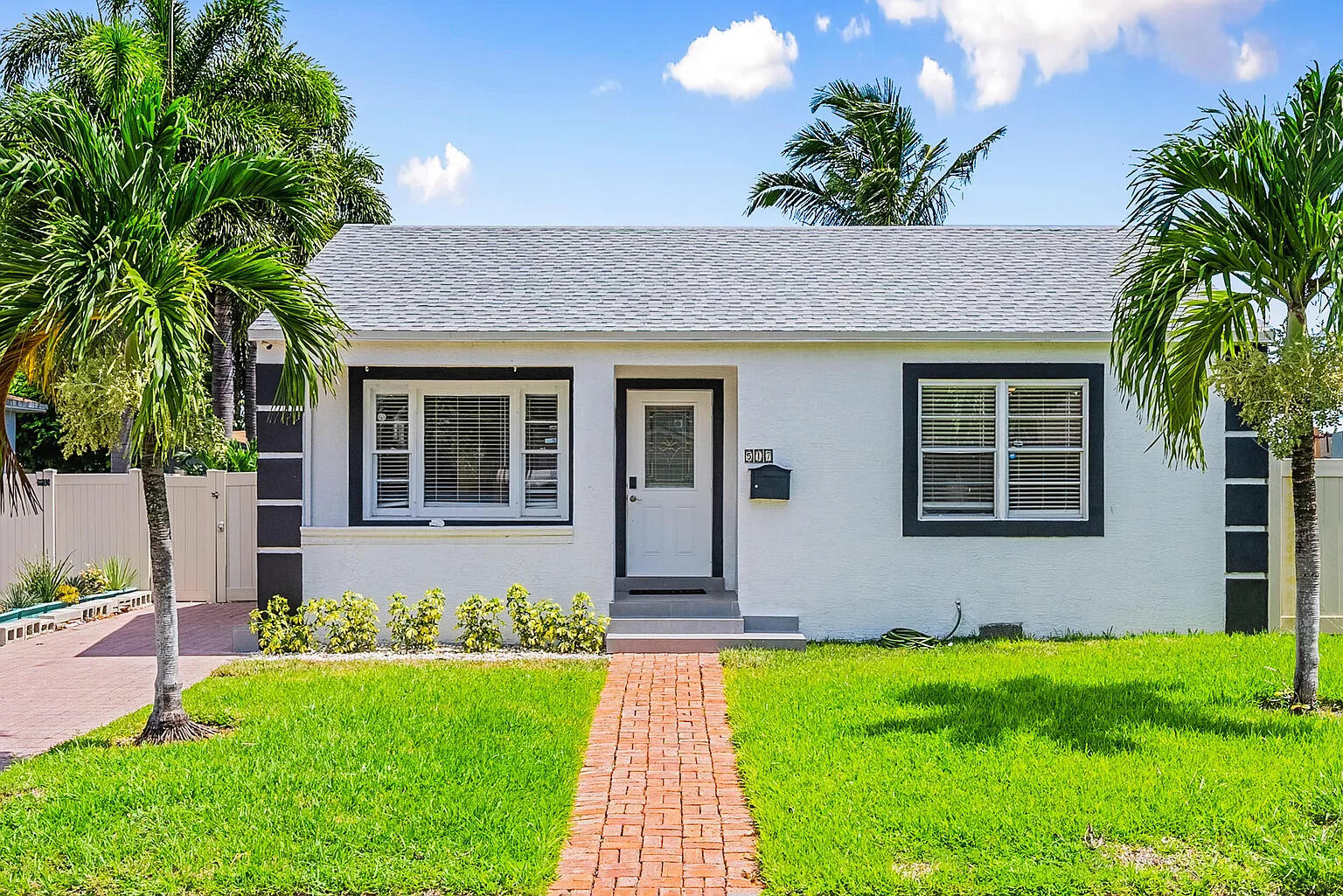 a front view of house with yard and green space