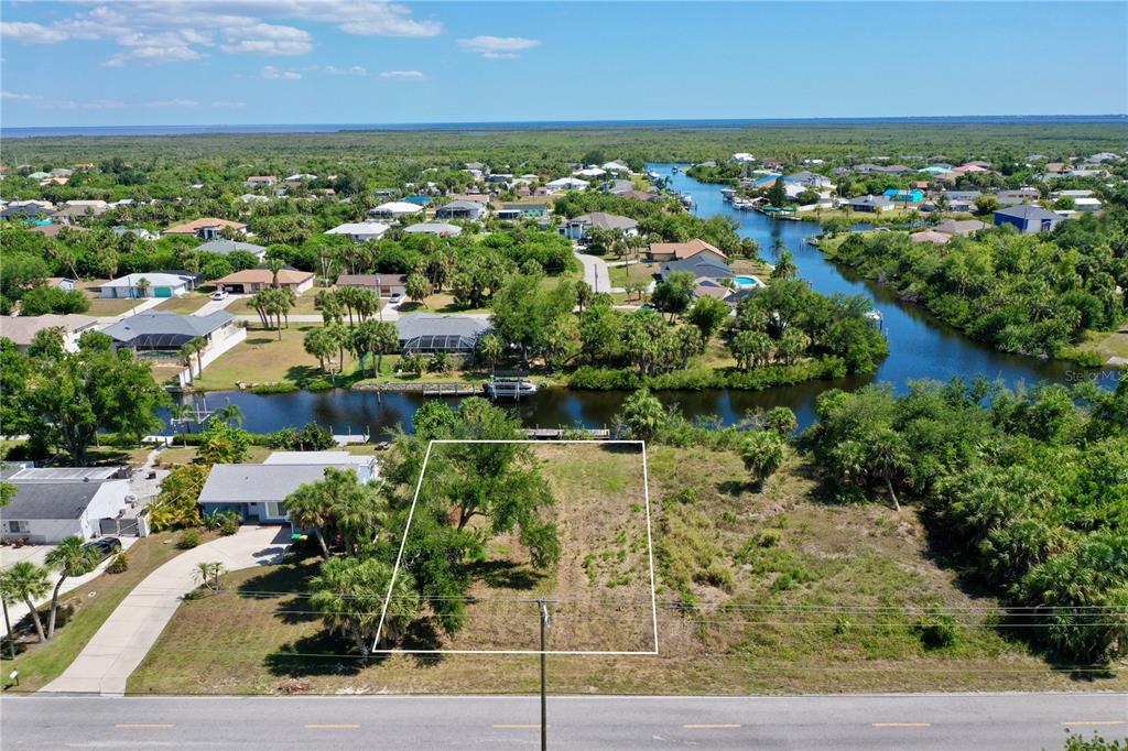 an aerial view of residential houses with outdoor space and trees