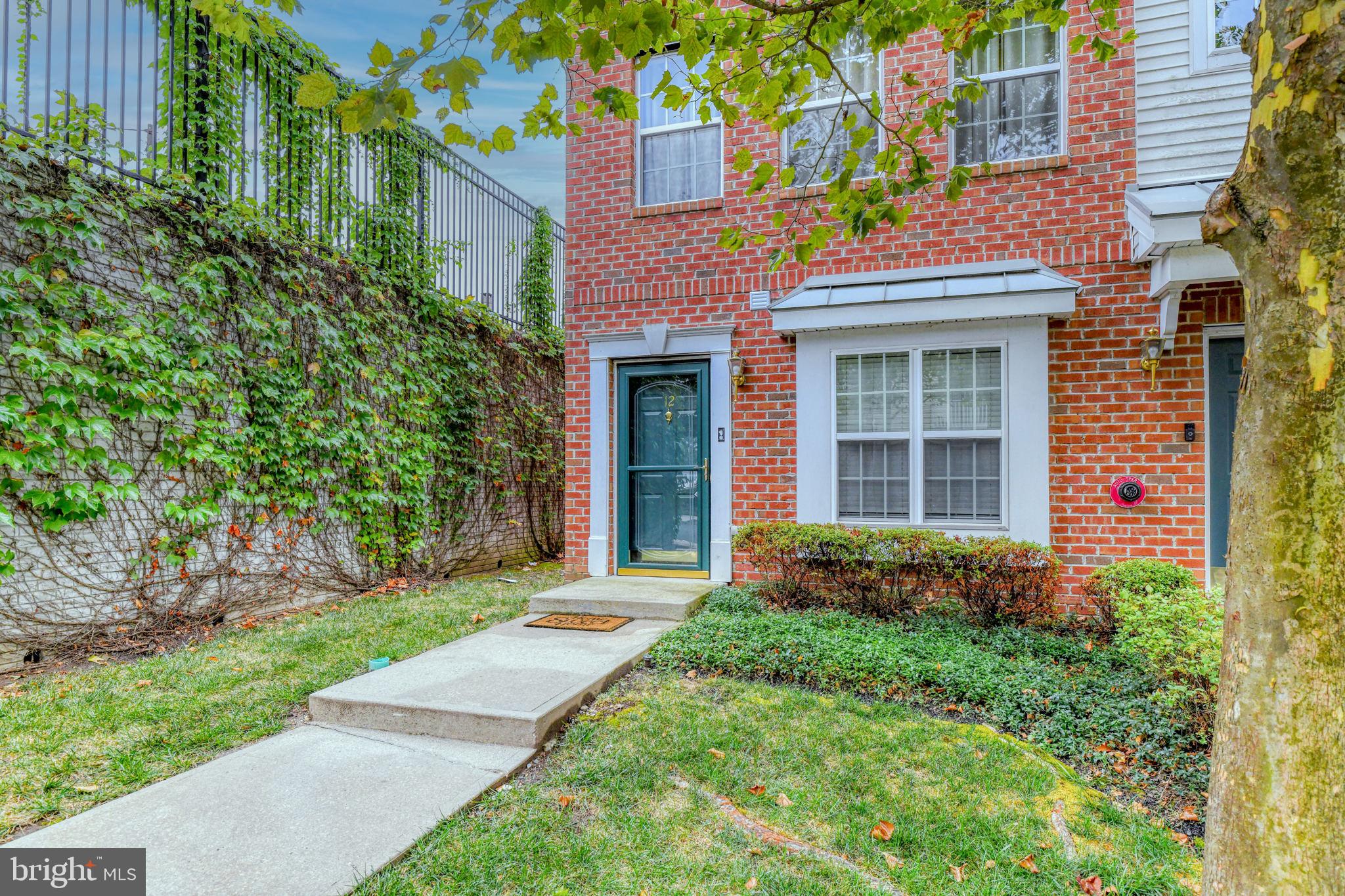 front view of a brick house with a yard