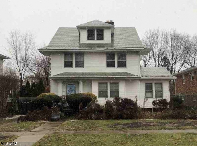 a front view of house with yard and trees