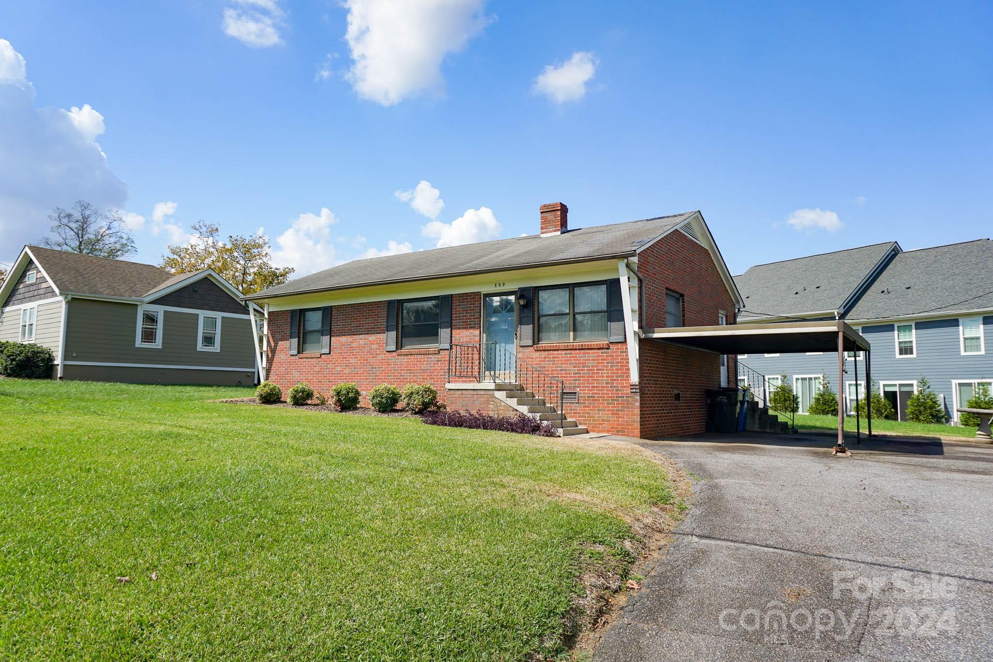 a view of a house with a yard and porch