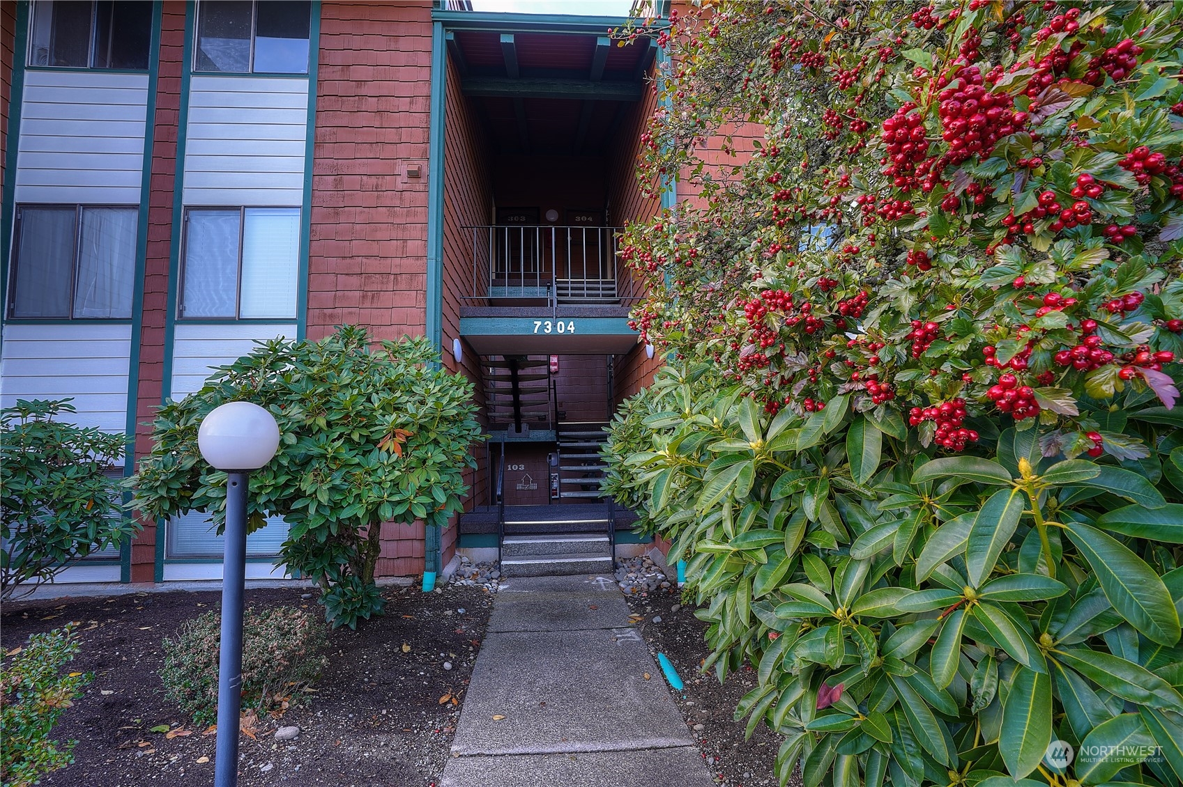 a front view of a house with a yard and fountain