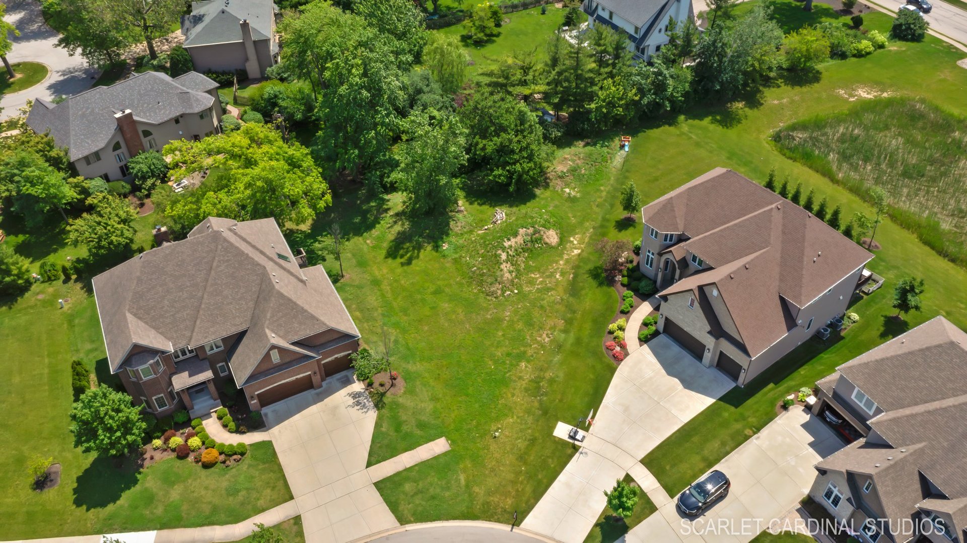 an aerial view of a house with garden space and street view