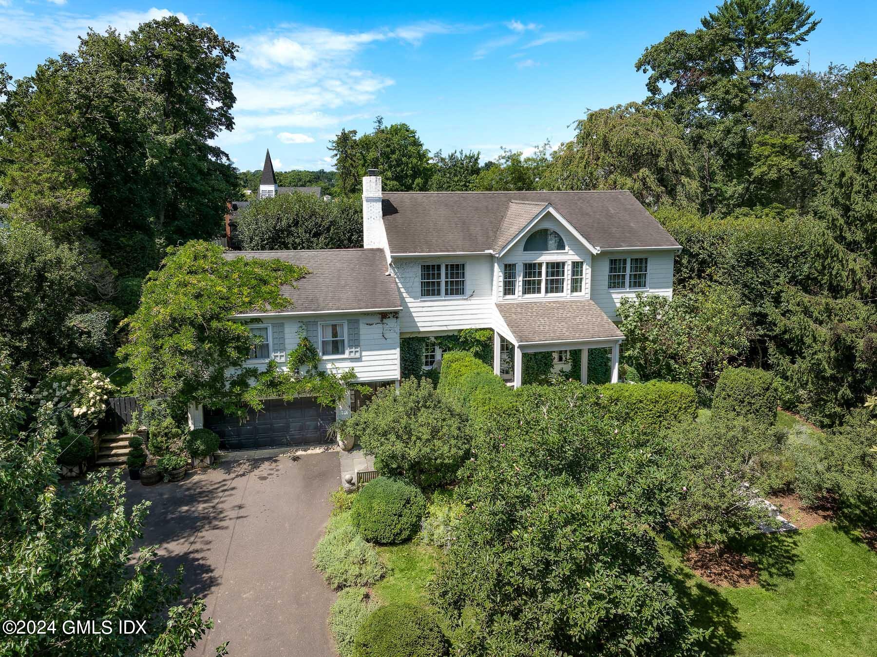 aerial view of a house with a yard and potted plants