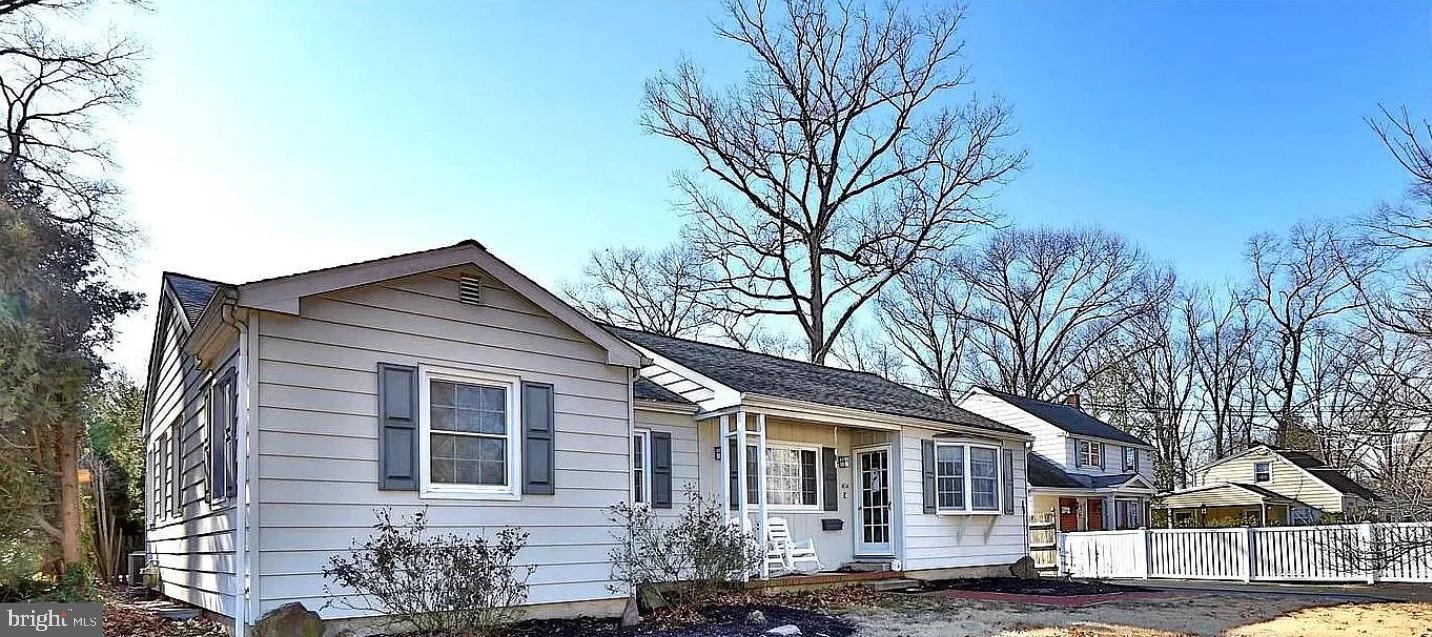 a front view of a house with a tree