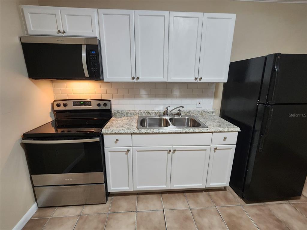 a kitchen with a stove and a refrigerator