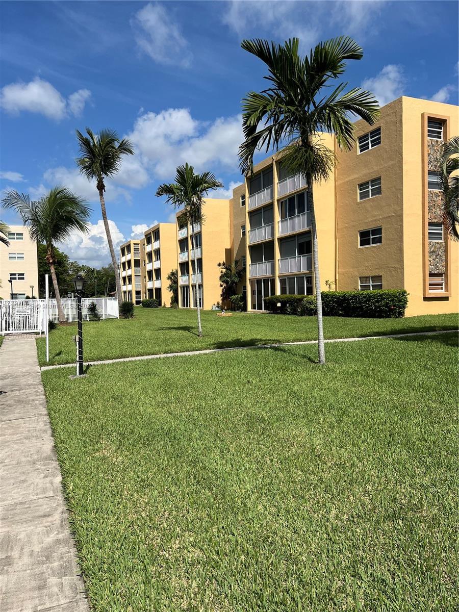 a view of a palm trees in front of a building