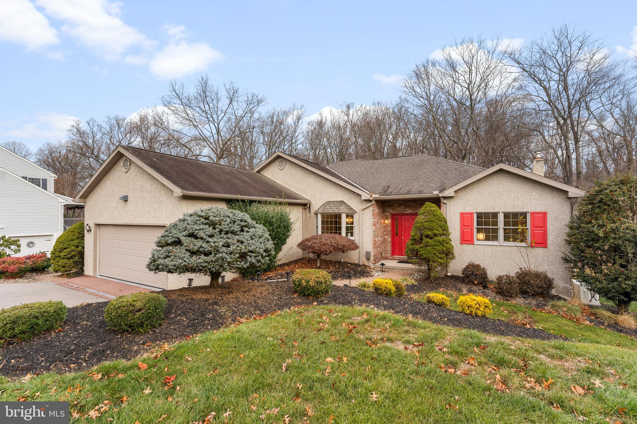 a front view of a house with a yard and outdoor seating