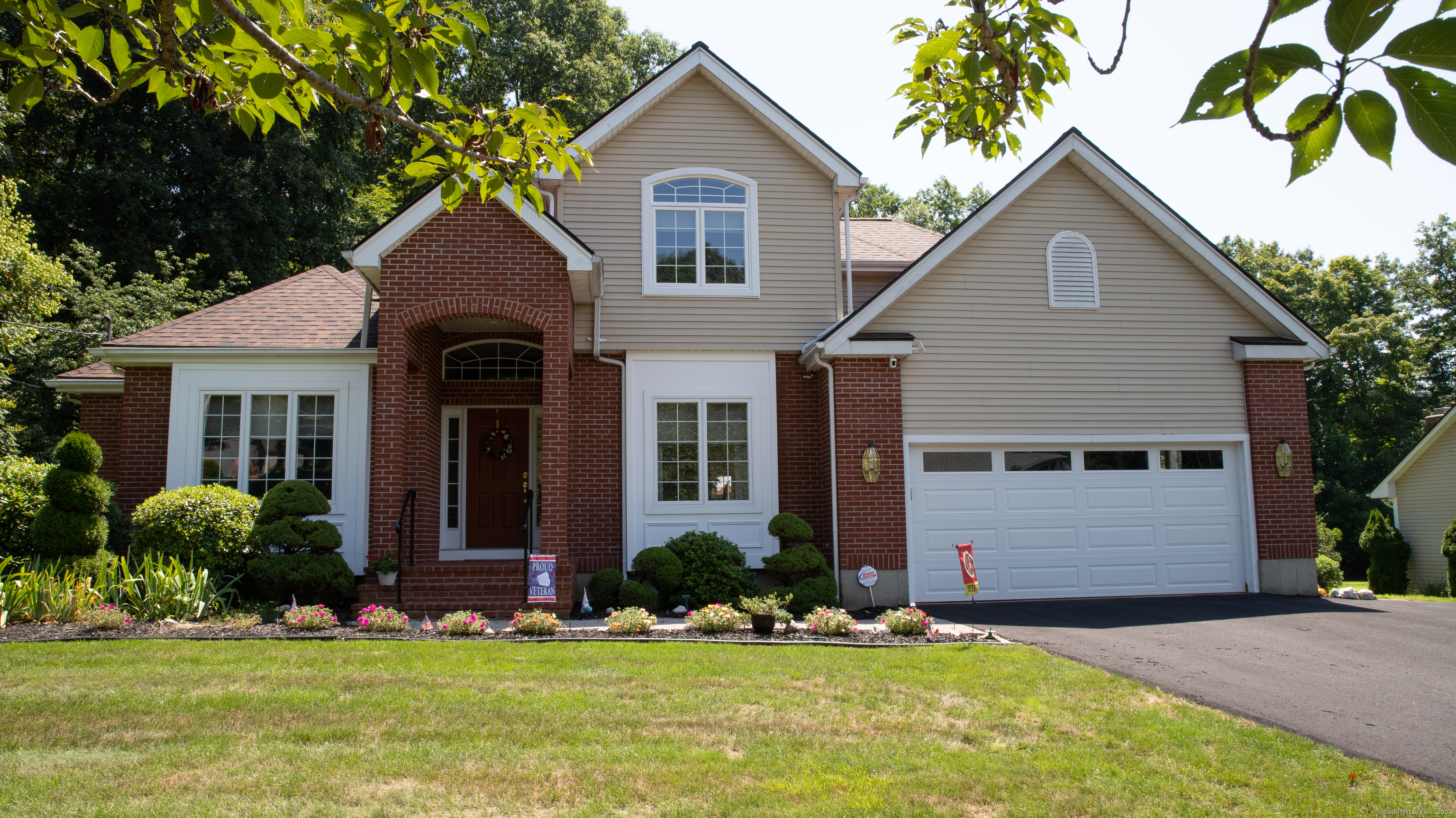 a front view of a house with a yard and garage