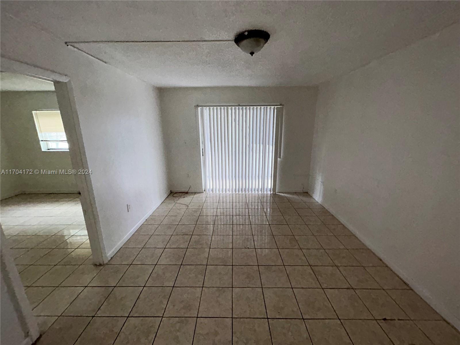 a view of an empty room and window