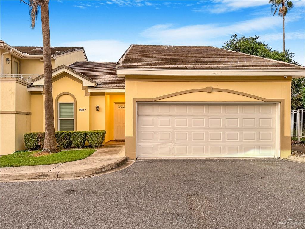 View of front of property with a 2 car garage - End unit