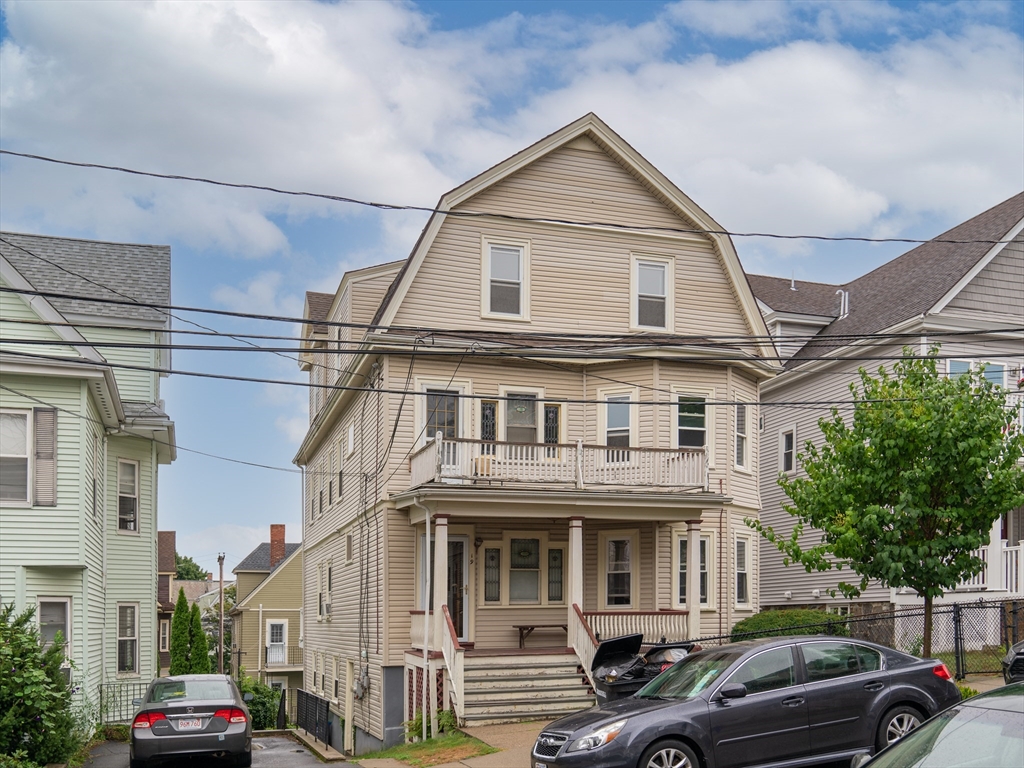 a front view of a residential apartment building with a yard