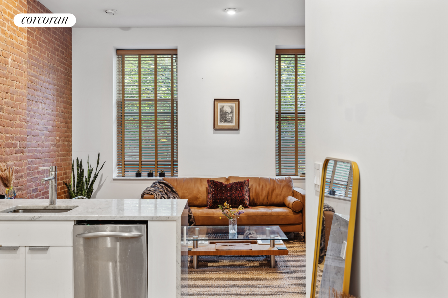 a living room with a couch and a potted plant