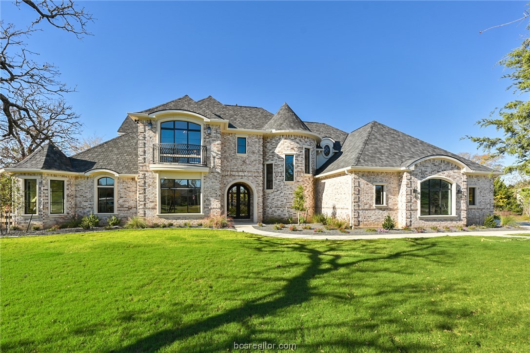 a front view of house with yard and green space