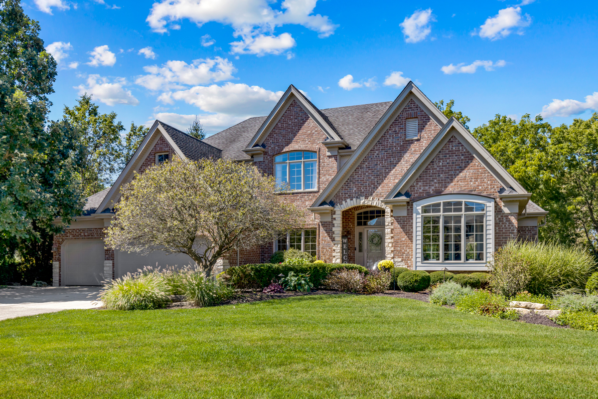 a front view of house with yard and green space