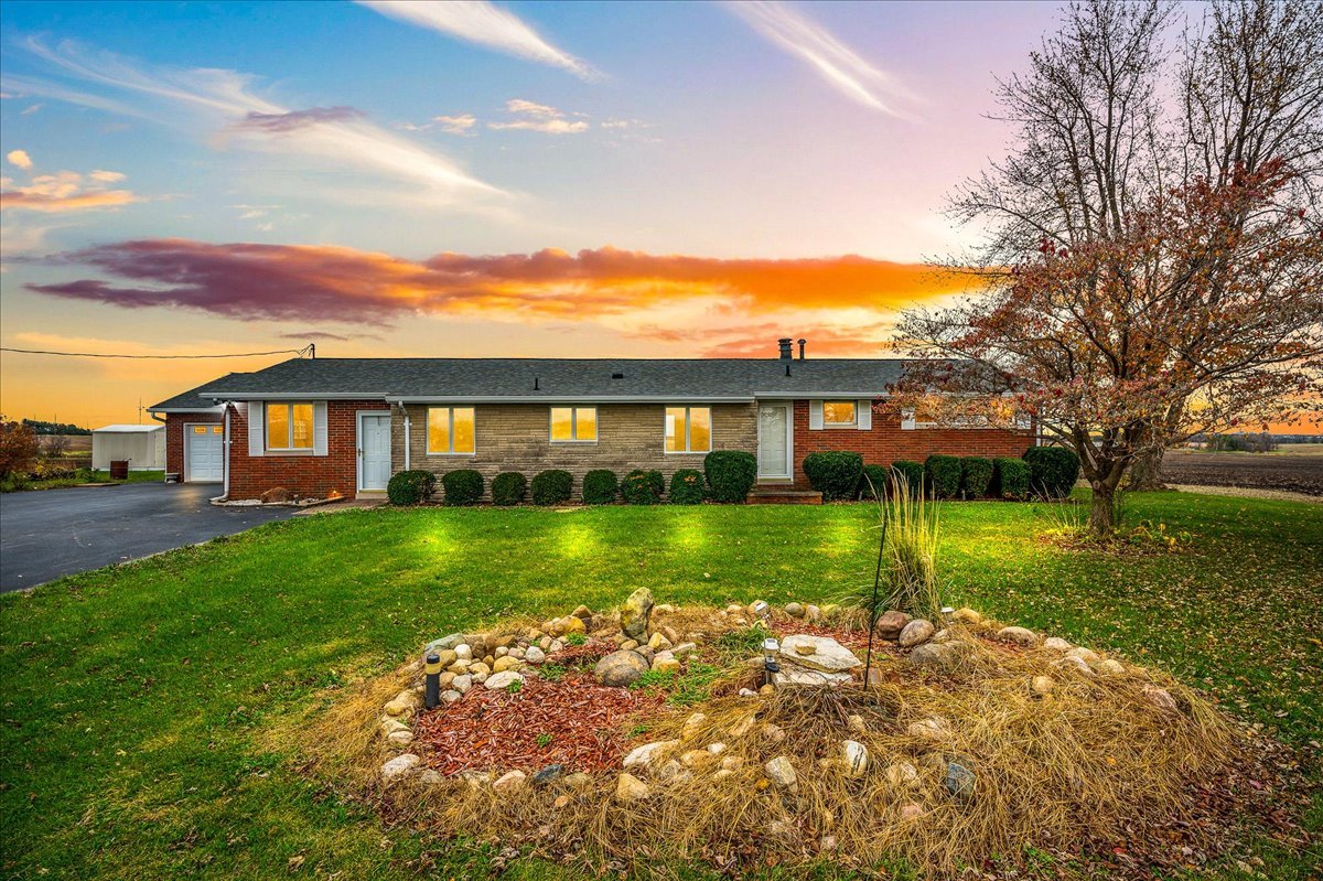 a view of a big yard with a house in the background