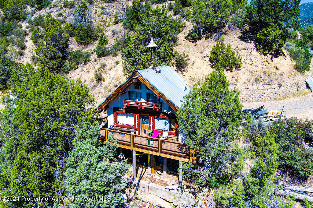 an aerial view of a house with a yard